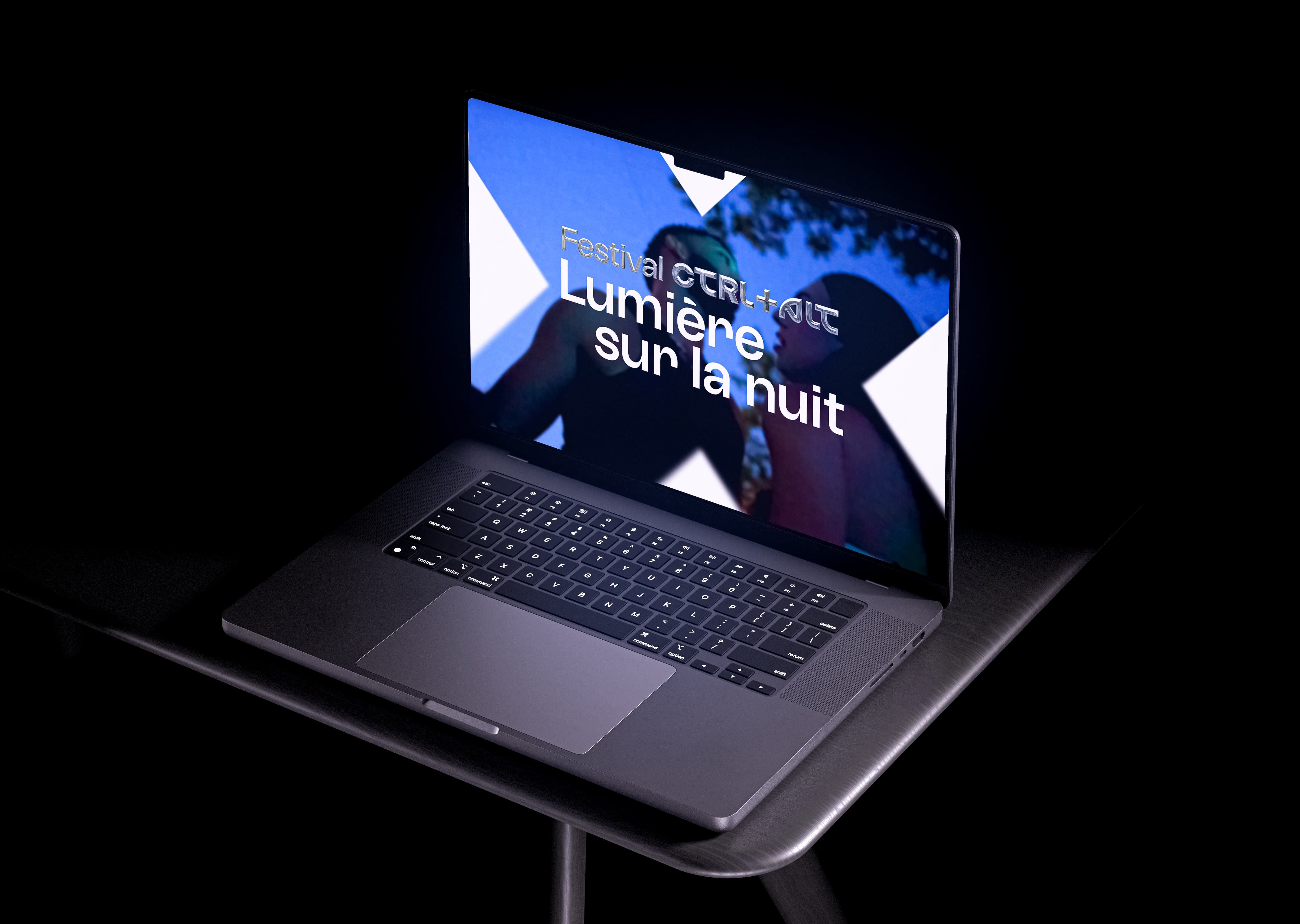 Open laptop screen in a dark studio
